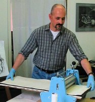 Brian Holden with printing press
