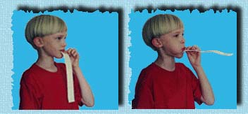 [Child blowing on paper]
